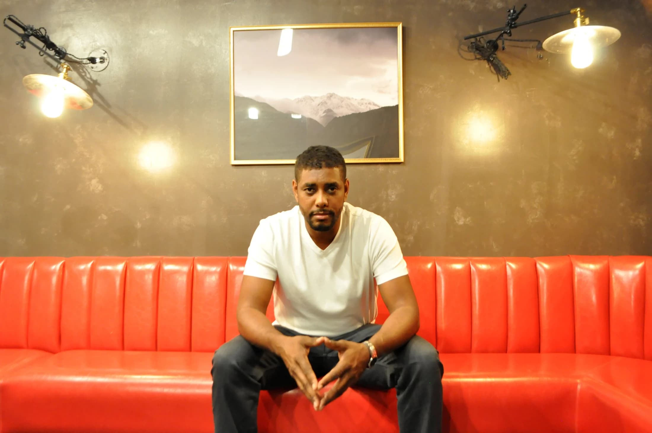 Garland sitting at a red banquette